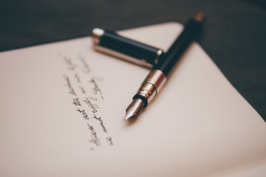 a fountain pen on top of a paper
