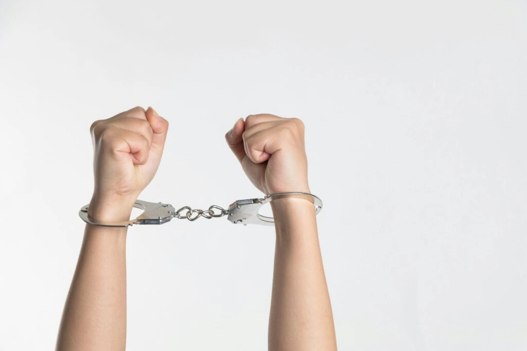 a person showing handcuffed hands