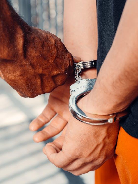 Person wearing metal handcuffs