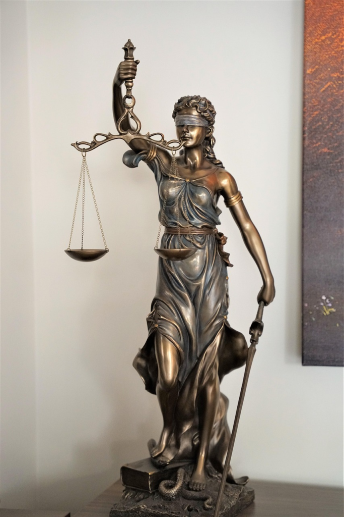 Golden lady statue holding a scale