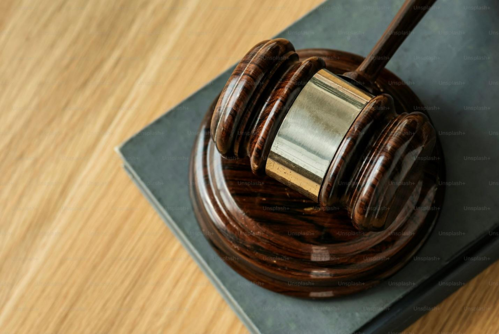 A brown gavel on a wooden table