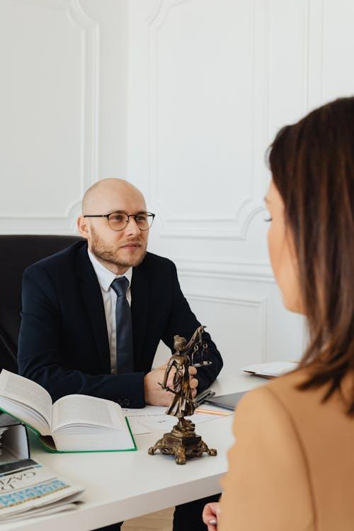 Lawyer consulting with clients in a professional law office setting representing local bail bond service