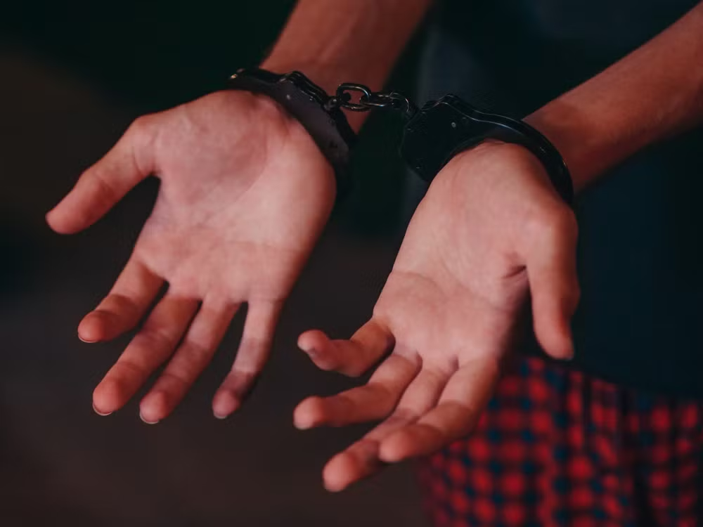 An image of a person in handcuffs