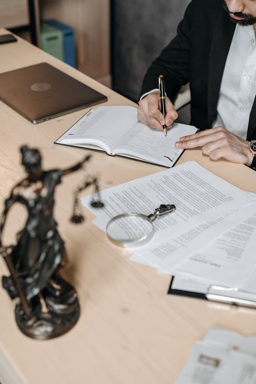 An image of a person writing in a notebook