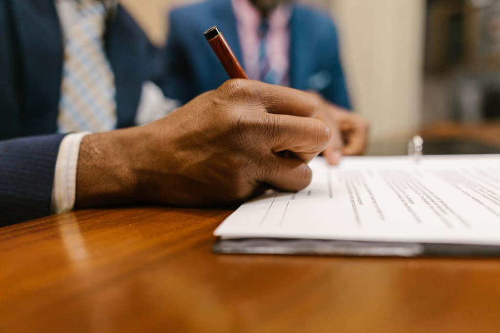 An image of a person signing bail paperwork